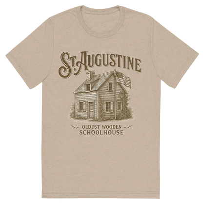 Front view of a Premium Tri-Blend Crew Neck T-Shirt in Tan showing 'A typographic, nostalgic graphic of a typographic illustration of the words 'st. augustine' with a vintage line art drawing of the oldest wooden schoolhouse'