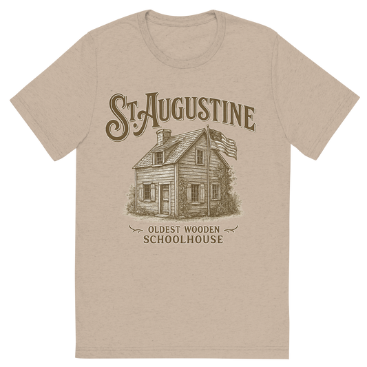 Front view of a Premium Tri-Blend Crew Neck T-Shirt in Tan showing 'A typographic, nostalgic graphic of a typographic illustration of the words 'st. augustine' with a vintage line art drawing of the oldest wooden schoolhouse'