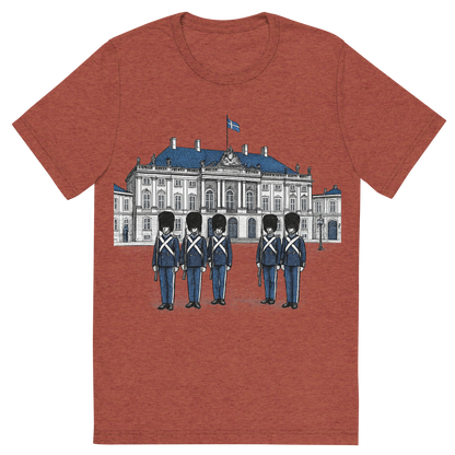 Front view of a Premium Tri-Blend Crew Neck T-Shirt in Clay showing 'A hand-drawn ink with pop color, formal graphic of a refined ink-style illustration of amalienborg palace with danish guards in front and the words “amalienborg palace” in gold-trim lettering above. transparent background, centered layout, royal blue and gray pops. optimized for dtg.'