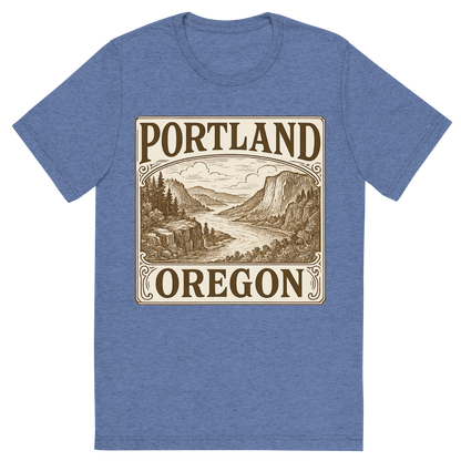 Front view of a Premium Tri-Blend Crew Neck T-Shirt in Blue showing 'A typographic, nostalgic graphic of a typographic illustration of the words 'portland, oregon' with a vintage line art drawing of the columbia river gorge'