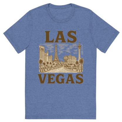 Front view of a Premium Tri-Blend Crew Neck T-Shirt in Blue showing 'A typographic, nostalgic graphic of a typographic illustration of the words 'las vegas' with a vintage line art drawing of the strip'