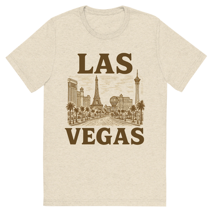 Front view of a Premium Tri-Blend Crew Neck T-Shirt in Oatmeal showing 'A typographic, nostalgic graphic of a typographic illustration of the words 'las vegas' with a vintage line art drawing of the strip'