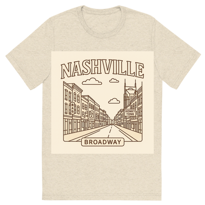 Front view of a Premium Tri-Blend Crew Neck T-Shirt in Oatmeal showing 'A minimalist, playful graphic of a typographic illustration of the words 'nashville' with a vintage line art drawing of broadway street'
