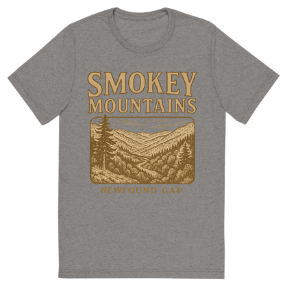 Front view of a Premium Tri-Blend Crew Neck T-Shirt in Grey showing 'A typographic, nostalgic graphic of a typographic illustration of the words 'smokey mountains' with a vintage line art drawing of the newfound gap'