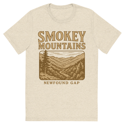 Front view of a Premium Tri-Blend Crew Neck T-Shirt in Oatmeal showing 'A typographic, nostalgic graphic of a typographic illustration of the words 'smokey mountains' with a vintage line art drawing of the newfound gap'