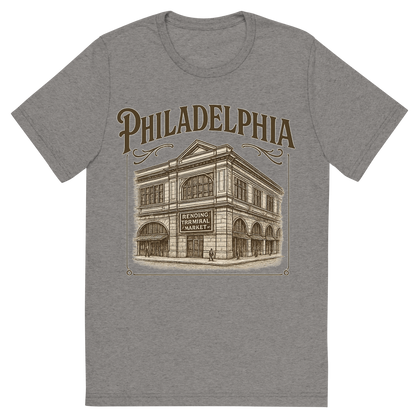 Front view of a Premium Tri-Blend Crew Neck T-Shirt in Grey showing 'A typographic, nostalgic graphic of a typographic illustration of the words 'philadelphia' with a vintage line art drawing of the reading terminal market'