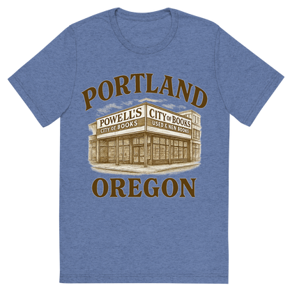 Front view of a Premium Tri-Blend Crew Neck T-Shirt in Blue showing 'A typographic, nostalgic graphic of a typographic illustration of the words 'portland, oregon' with a vintage line art drawing of powell’s city of books'