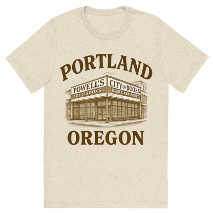 Front view of a Premium Tri-Blend Crew Neck T-Shirt in Oatmeal showing 'A typographic, nostalgic graphic of a typographic illustration of the words 'portland, oregon' with a vintage line art drawing of powell’s city of books'
