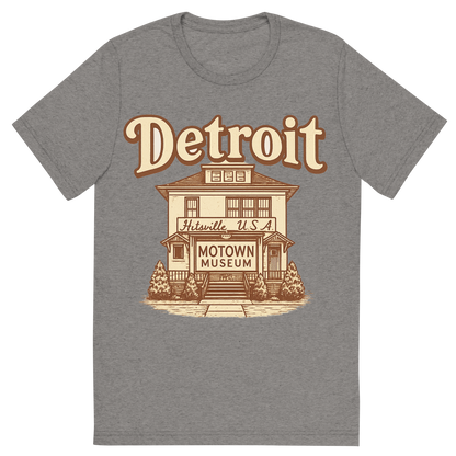 Front view of a Premium Tri-Blend Crew Neck T-Shirt in Grey showing 'A typographic, nostalgic graphic of a typographic illustration of the words 'detroit' with a vintage line art drawing of the motown museum'