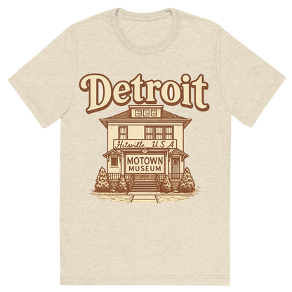 Front view of a Premium Tri-Blend Crew Neck T-Shirt in Oatmeal showing 'A typographic, nostalgic graphic of a typographic illustration of the words 'detroit' with a vintage line art drawing of the motown museum'