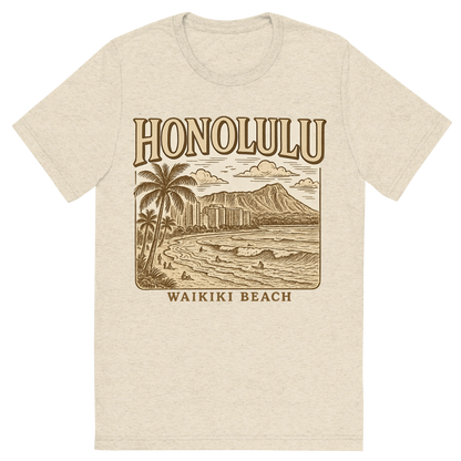 Front view of a Premium Tri-Blend Crew Neck T-Shirt in Oatmeal showing 'A typographic, nostalgic graphic of a typographic illustration of the words 'honolulu' with a vintage line art drawing of waikiki beach'