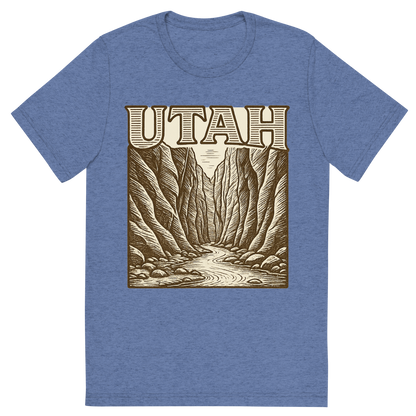 Front view of a Premium Tri-Blend Crew Neck T-Shirt in Blue showing 'A typographic, nostalgic graphic of a typographic illustration of the words 'utah' with a vintage line art drawing of the the narrows'