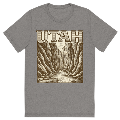 Front view of a Premium Tri-Blend Crew Neck T-Shirt in Grey showing 'A typographic, nostalgic graphic of a typographic illustration of the words 'utah' with a vintage line art drawing of the the narrows'