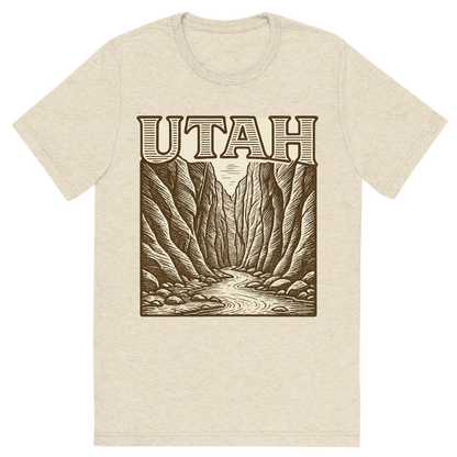 Front view of a Premium Tri-Blend Crew Neck T-Shirt in Oatmeal showing 'A typographic, nostalgic graphic of a typographic illustration of the words 'utah' with a vintage line art drawing of the the narrows'