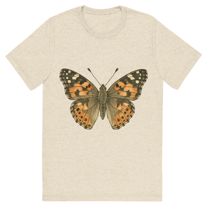 Front view of a Premium Tri-Blend Crew Neck T-Shirt in Oatmeal showing 'A hand-drawn, tranquil graphic of painted lady butterfly'