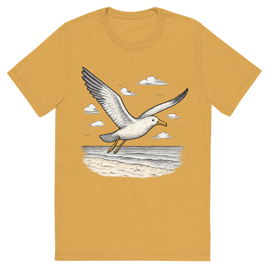 Front view of a Premium Tri-Blend Crew Neck T-Shirt in Mustard showing 'A hand-drawn ink with pops of color, free graphic of a hand-drawn seagull soaring above the beach with wings outstretched, subtle pops of gray and yellow, centered composition, transparent background, optimized for dtg printing'