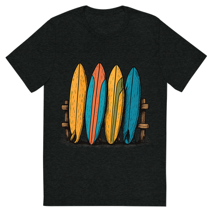 Front view of a Premium Tri-Blend Crew Neck T-Shirt in Charcoal-Black showing 'A hand-drawn ink with pops of color, playful graphic of a stylized stack of colorful vintage surfboards leaning against a wooden fence, hand-drawn ink with pops of color, centered composition, transparent background, optimized for dtg printing'