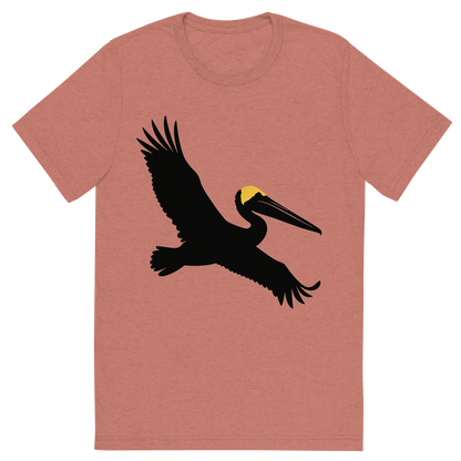 Front view of a Premium Tri-Blend Crew Neck T-Shirt in Mauve showing 'A high-contrast silhouette with minimal accent color, majestic graphic of a large silhouette of a brown pelican gliding with wings stretched and pouch visible, yellow crown highlighted in color, transparent background, optimized for dtg printing'