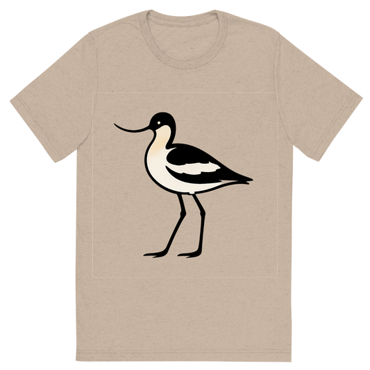 Front view of a Premium Tri-Blend Crew Neck T-Shirt in Tan showing 'A high-contrast silhouette with minimal accent color, poised graphic of a stylized silhouette of an avocet with its signature upturned bill and long legs, black-and-white body accented with warm buff tones, transparent background, optimized for dtg printing'