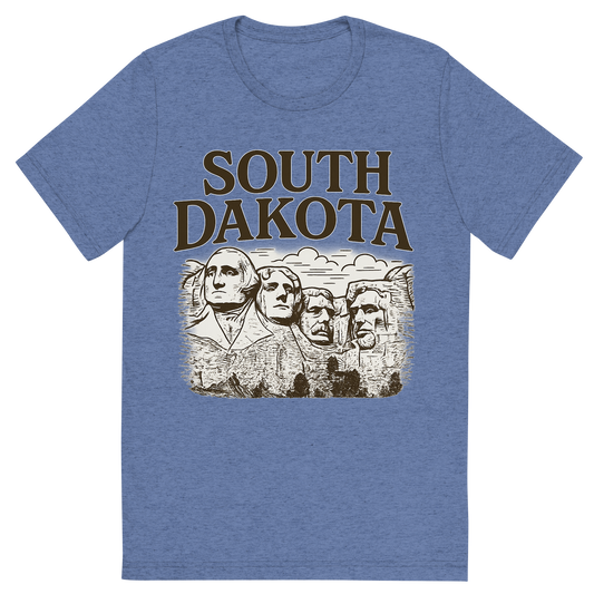 Front view of a Premium Tri-Blend Crew Neck T-Shirt in Blue showing 'A typographic, nostalgic graphic of a typographic illustration of the words 'south dakota' with a vintage line art drawing of the presidential sculptures'