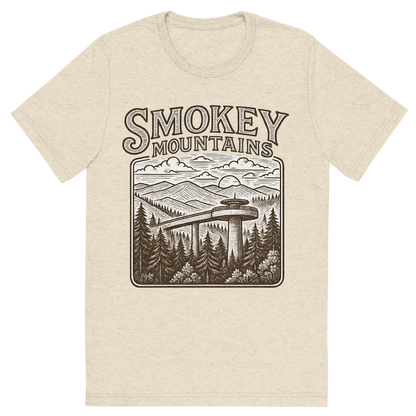 Front view of a Premium Tri-Blend Crew Neck T-Shirt in Oatmeal showing 'A typographic, nostalgic graphic of a typographic illustration of the words 'smokey mountains' with a vintage line art drawing of clingmans dome'