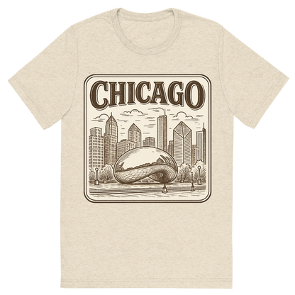 Front view of a Premium Tri-Blend Crew Neck T-Shirt in Oatmeal showing 'A typographic, nostalgic graphic of a typographic illustration of the words 'chicago' with a vintage line art drawing of millennium park'