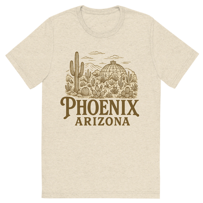 Front view of a Premium Tri-Blend Crew Neck T-Shirt in Oatmeal showing 'A typographic, nostalgic graphic of a typographic illustration of the words 'phoenix, arizona' with a vintage line art drawing of the desert botanical garden'