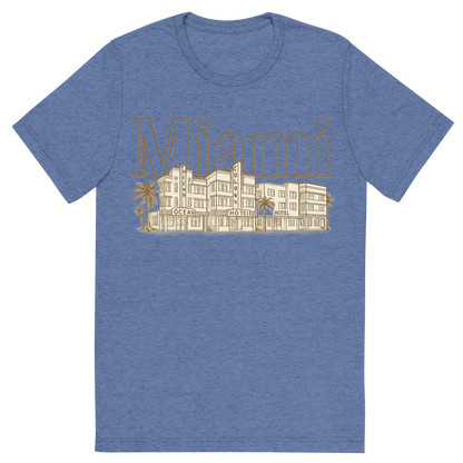 Front view of a Premium Tri-Blend Crew Neck T-Shirt in Blue showing 'A typographic, nostalgic graphic of a typographic illustration of the words 'miami' with a vintage line art drawing of the art deco historic district'