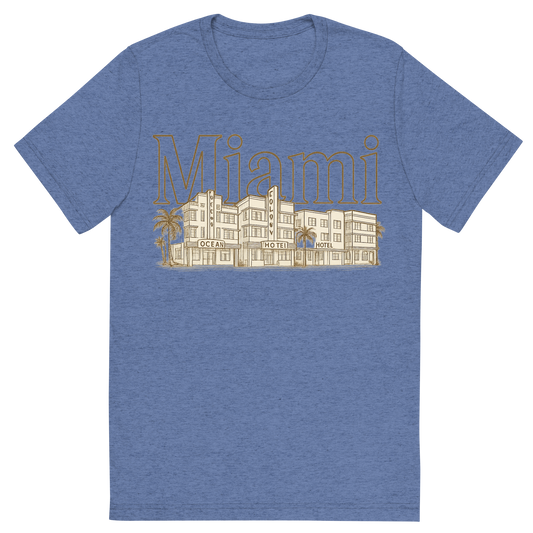 Front view of a Premium Tri-Blend Crew Neck T-Shirt in Blue showing 'A typographic, nostalgic graphic of a typographic illustration of the words 'miami' with a vintage line art drawing of the art deco historic district'