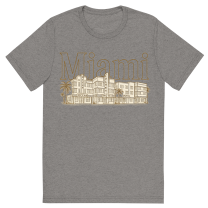 Front view of a Premium Tri-Blend Crew Neck T-Shirt in Grey showing 'A typographic, nostalgic graphic of a typographic illustration of the words 'miami' with a vintage line art drawing of the art deco historic district'