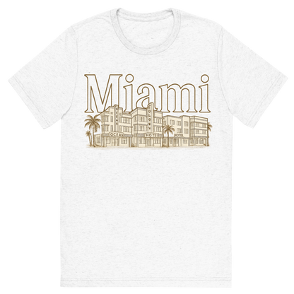 Front view of a Premium Tri-Blend Crew Neck T-Shirt in Solid White showing 'A typographic, nostalgic graphic of a typographic illustration of the words 'miami' with a vintage line art drawing of the art deco historic district'