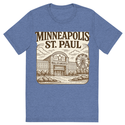 Front view of a Premium Tri-Blend Crew Neck T-Shirt in Blue showing 'A typographic, nostalgic graphic of a typographic illustration of the words 'minneapolis-st. paul' with a vintage line art drawing of the mall of america'