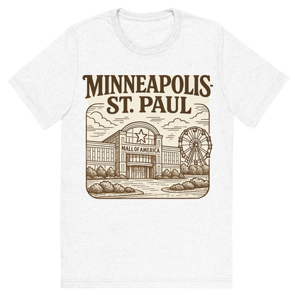 Front view of a Premium Tri-Blend Crew Neck T-Shirt in Solid White showing 'A typographic, nostalgic graphic of a typographic illustration of the words 'minneapolis-st. paul' with a vintage line art drawing of the mall of america'