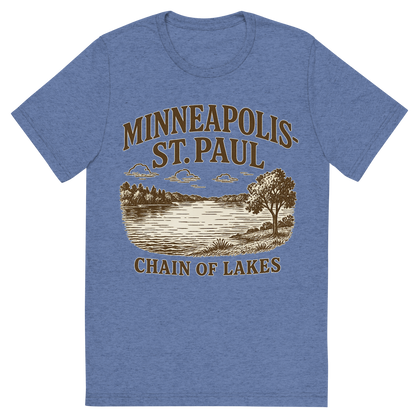 Front view of a Premium Tri-Blend Crew Neck T-Shirt in Blue showing 'A typographic, nostalgic graphic of a typographic illustration of the words 'minneapolis-st. paul' with a vintage line art drawing of the chain of lakes'