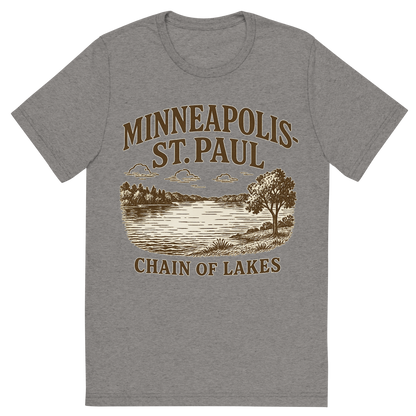 Front view of a Premium Tri-Blend Crew Neck T-Shirt in Grey showing 'A typographic, nostalgic graphic of a typographic illustration of the words 'minneapolis-st. paul' with a vintage line art drawing of the chain of lakes'