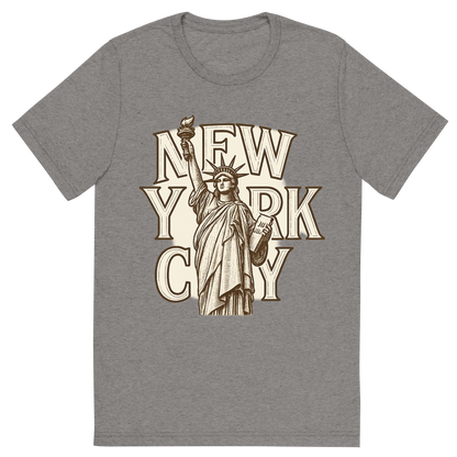 Front view of a Premium Tri-Blend Crew Neck T-Shirt in Grey showing 'A typographic, nostalgic graphic of a typographic illustration of the words 'new york city' with a vintage line art drawing of the statue of liberty'