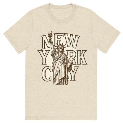 Front view of a Premium Tri-Blend Crew Neck T-Shirt in Oatmeal showing 'A typographic, nostalgic graphic of a typographic illustration of the words 'new york city' with a vintage line art drawing of the statue of liberty'