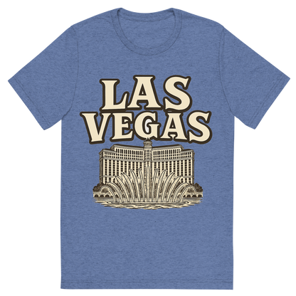Front view of a Premium Tri-Blend Crew Neck T-Shirt in Blue showing 'A typographic, nostalgic graphic of a typographic illustration of the words 'las vegas' with a vintage line art drawing of the bellagio fountains'