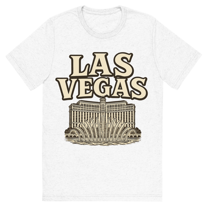 Front view of a Premium Tri-Blend Crew Neck T-Shirt in Solid White showing 'A typographic, nostalgic graphic of a typographic illustration of the words 'las vegas' with a vintage line art drawing of the bellagio fountains'