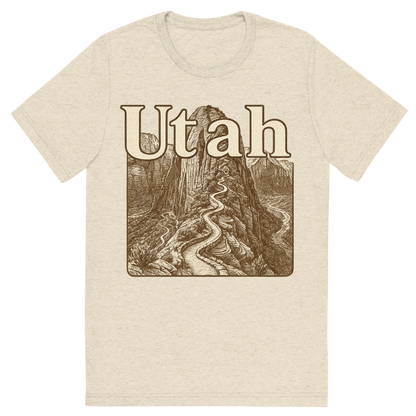 Front view of a Premium Tri-Blend Crew Neck T-Shirt in Oatmeal showing 'A typographic, nostalgic graphic of a typographic illustration of the words 'utah' with a vintage line art drawing of the angels landing trail'