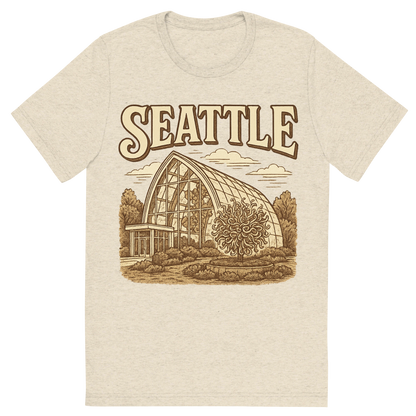 Front view of a Premium Tri-Blend Crew Neck T-Shirt in Oatmeal showing 'A typographic, nostalgic graphic of a typographic illustration of the words 'seattle' with a vintage line art drawing of the chihuly garden and glass'
