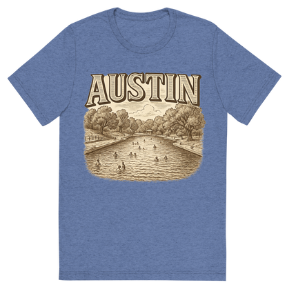 Front view of a Premium Tri-Blend Crew Neck T-Shirt in Blue showing 'A typographic, nostalgic graphic of a typographic illustration of the words 'austin' with a vintage line art drawing of the barton springs pool'