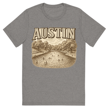 Front view of a Premium Tri-Blend Crew Neck T-Shirt in Grey showing 'A typographic, nostalgic graphic of a typographic illustration of the words 'austin' with a vintage line art drawing of the barton springs pool'