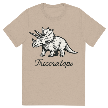 Front view of a Premium Tri-Blend Crew Neck T-Shirt in Tan showing 'A flat, neutral graphic of a stylized sketch of a triceratops with three horns and a frilled head. “triceratops” appears in graceful cursive below. ink illustration on a white background.'