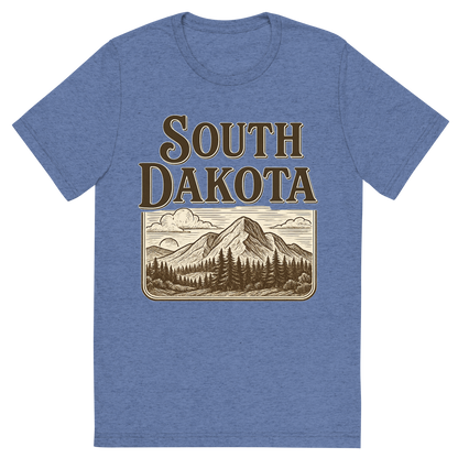 Front view of a Premium Tri-Blend Crew Neck T-Shirt in Blue showing 'A typographic, nostalgic graphic of a typographic illustration of the words 'south dakota' with a vintage line art drawing of the black hills'