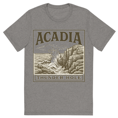 Front view of a Premium Tri-Blend Crew Neck T-Shirt in Grey showing 'A typographic, nostalgic graphic of a typographic illustration of the words 'acadia' with a vintage line art drawing of thunder hole'