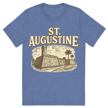 Front view of a Premium Tri-Blend Crew Neck T-Shirt in Blue showing 'A typographic, nostalgic graphic of a typographic illustration of the words 'st. augustine' with a vintage line art drawing of the castillo de san marcos'