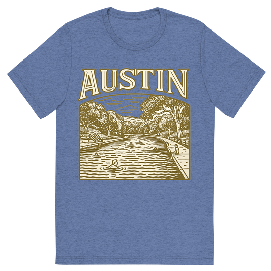 Front view of a Premium Tri-Blend Crew Neck T-Shirt in Blue showing 'A typographic, nostalgic graphic of a typographic illustration of the words 'austin' with a vintage line art drawing of the barton springs pool'