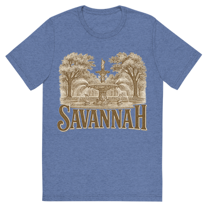 Front view of a Premium Tri-Blend Crew Neck T-Shirt in Blue showing 'A typographic, nostalgic graphic of a typographic illustration of the words 'savannah' with a vintage line art drawing of forsyth park'