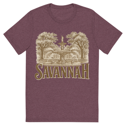 Front view of a Premium Tri-Blend Crew Neck T-Shirt in Maroon showing 'A typographic, nostalgic graphic of a typographic illustration of the words 'savannah' with a vintage line art drawing of forsyth park'